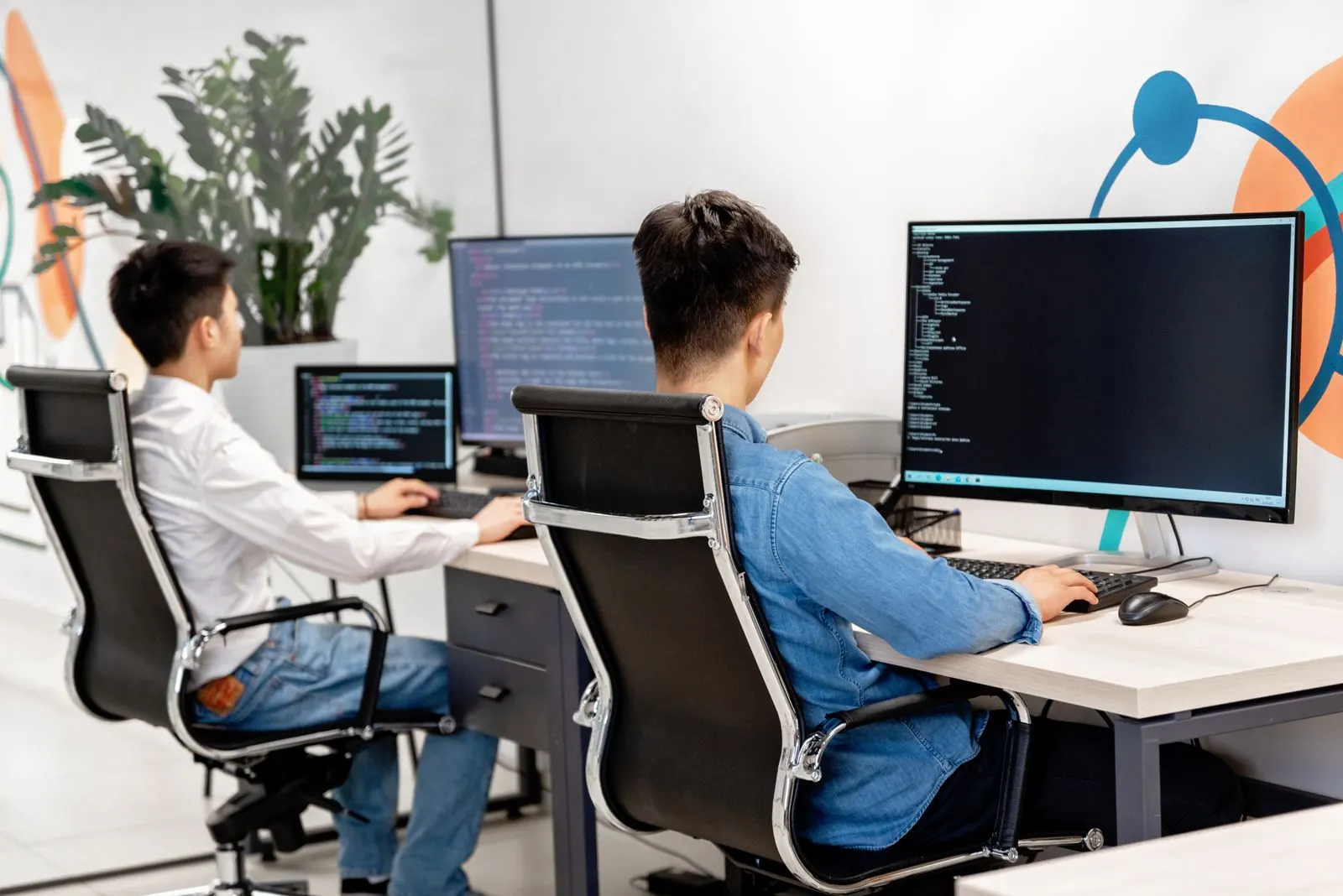 Two developers working at their desks